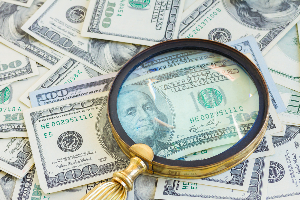 Magnifying glass over money